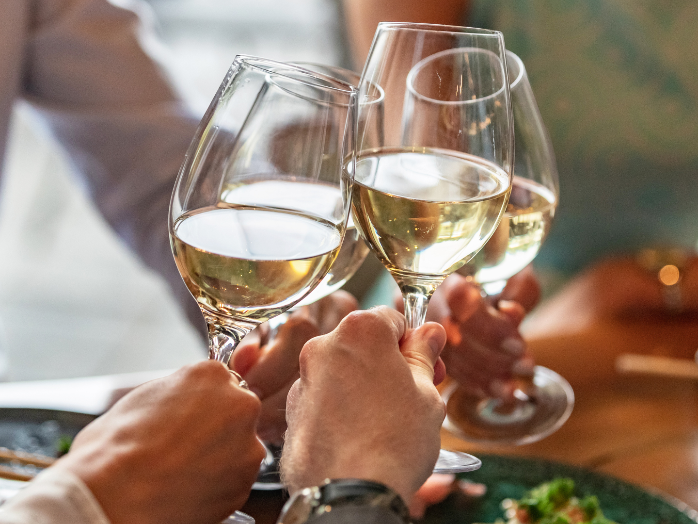 a hand holding a glass of wine