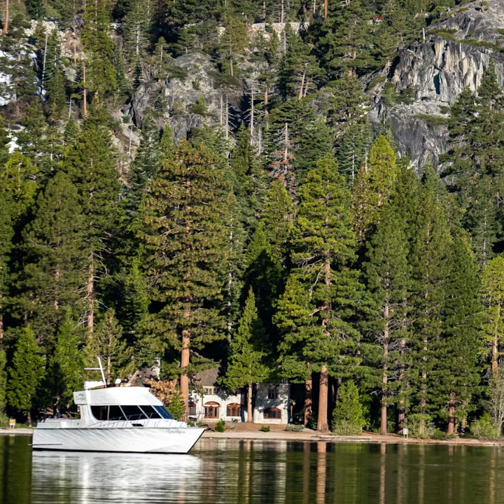 a small boat in a body of water surrounded by a forest