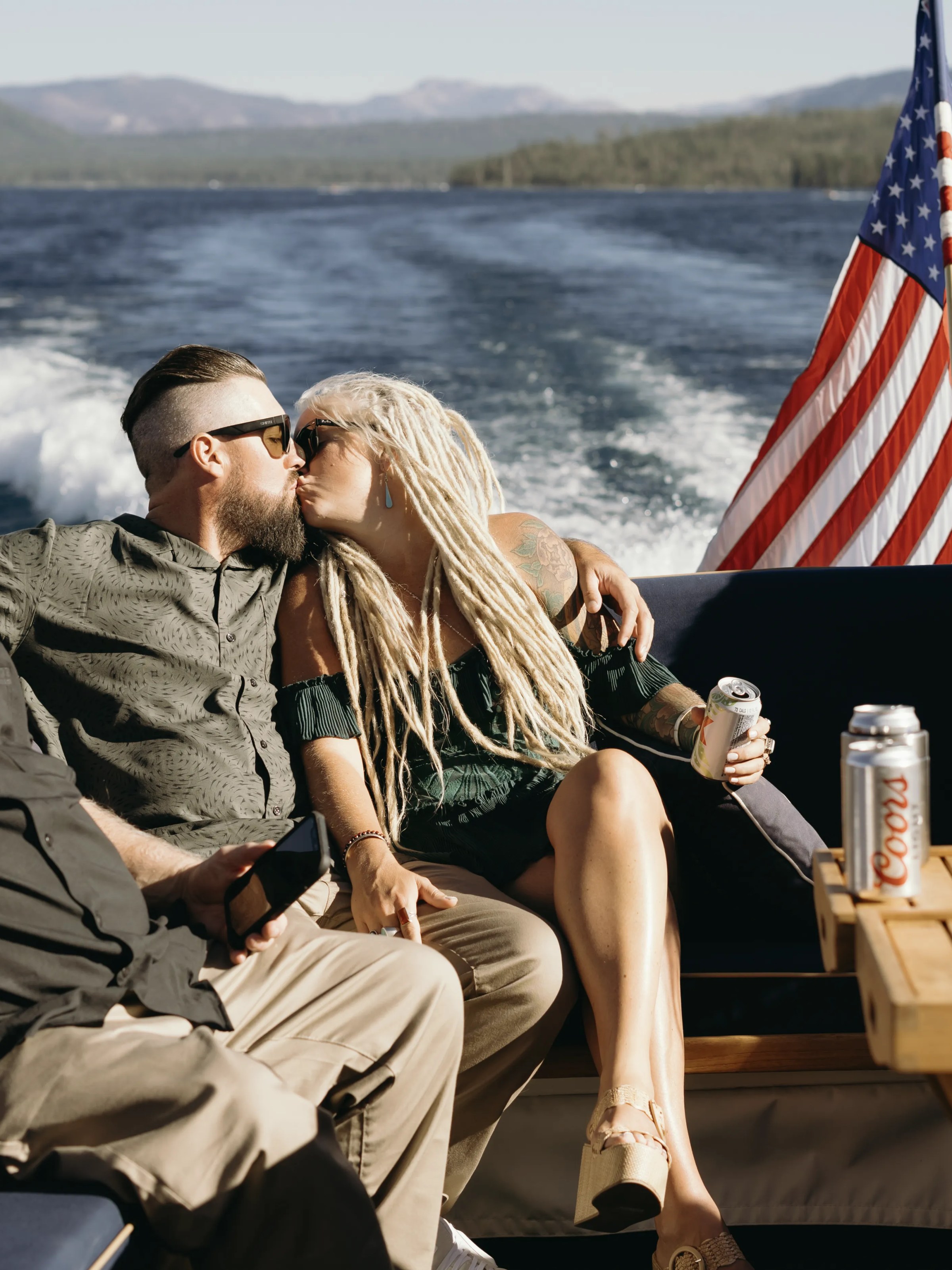 a man sitting on a bench next to a body of water