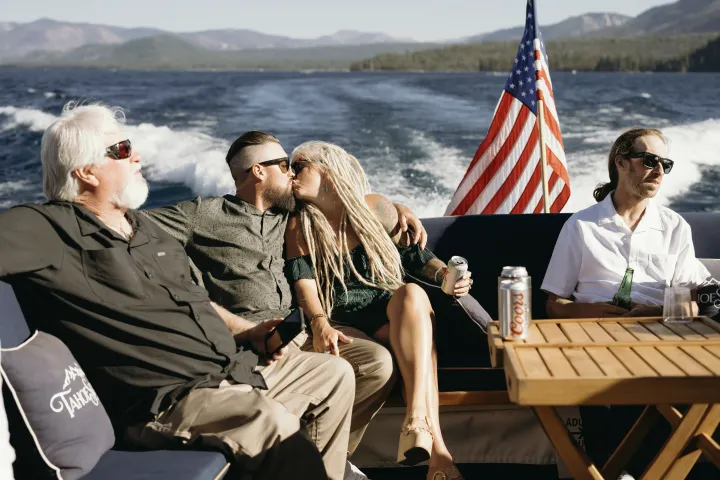 a man sitting on a bench next to a body of water