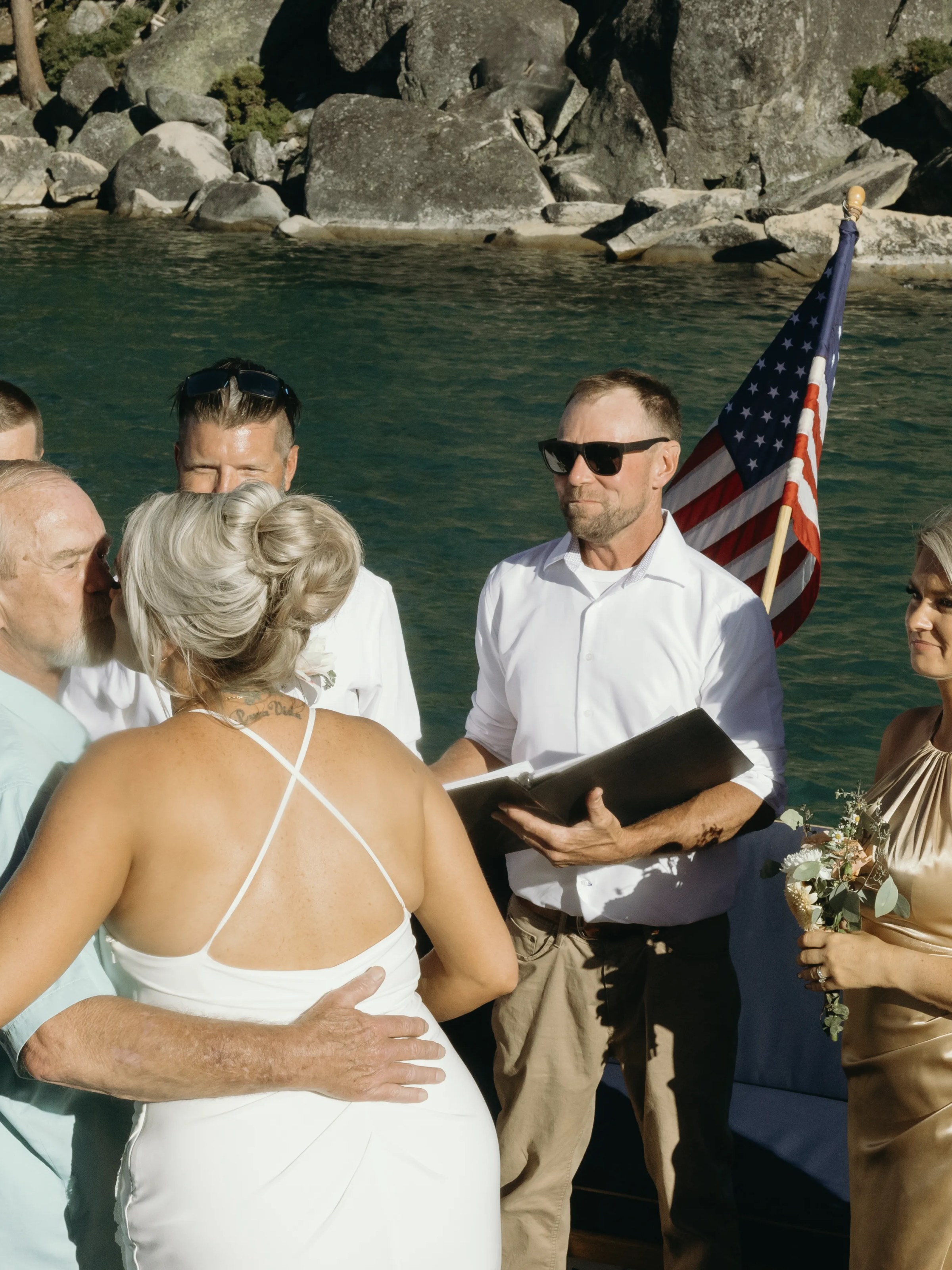 a couple of people that are standing in front of a body of water