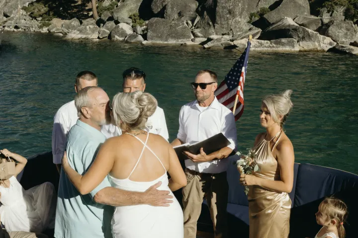 a couple of people that are standing in front of a body of water