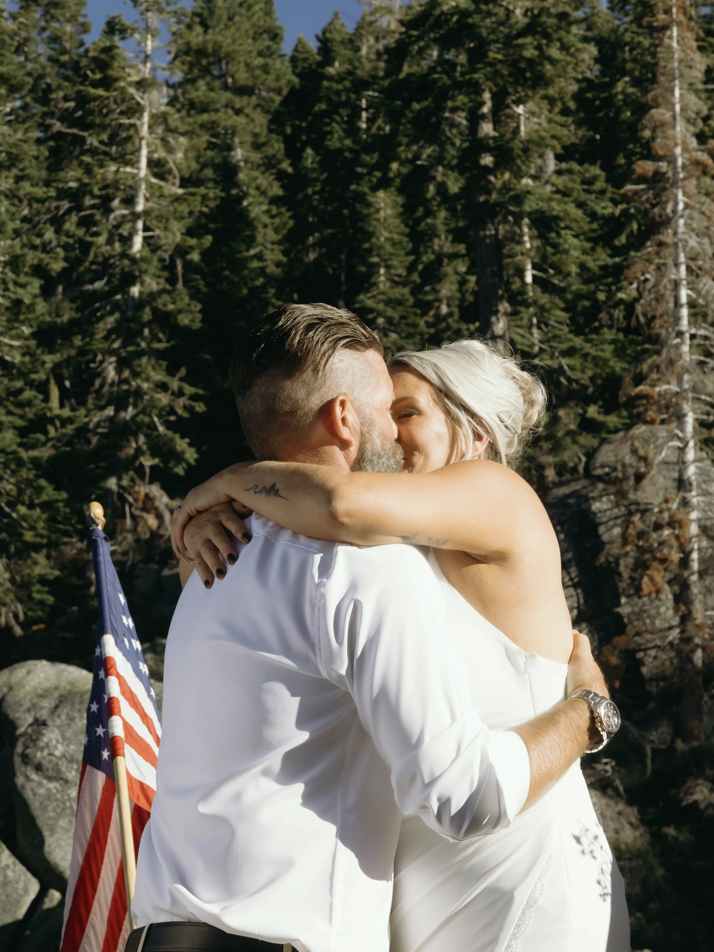a man standing next to a forest