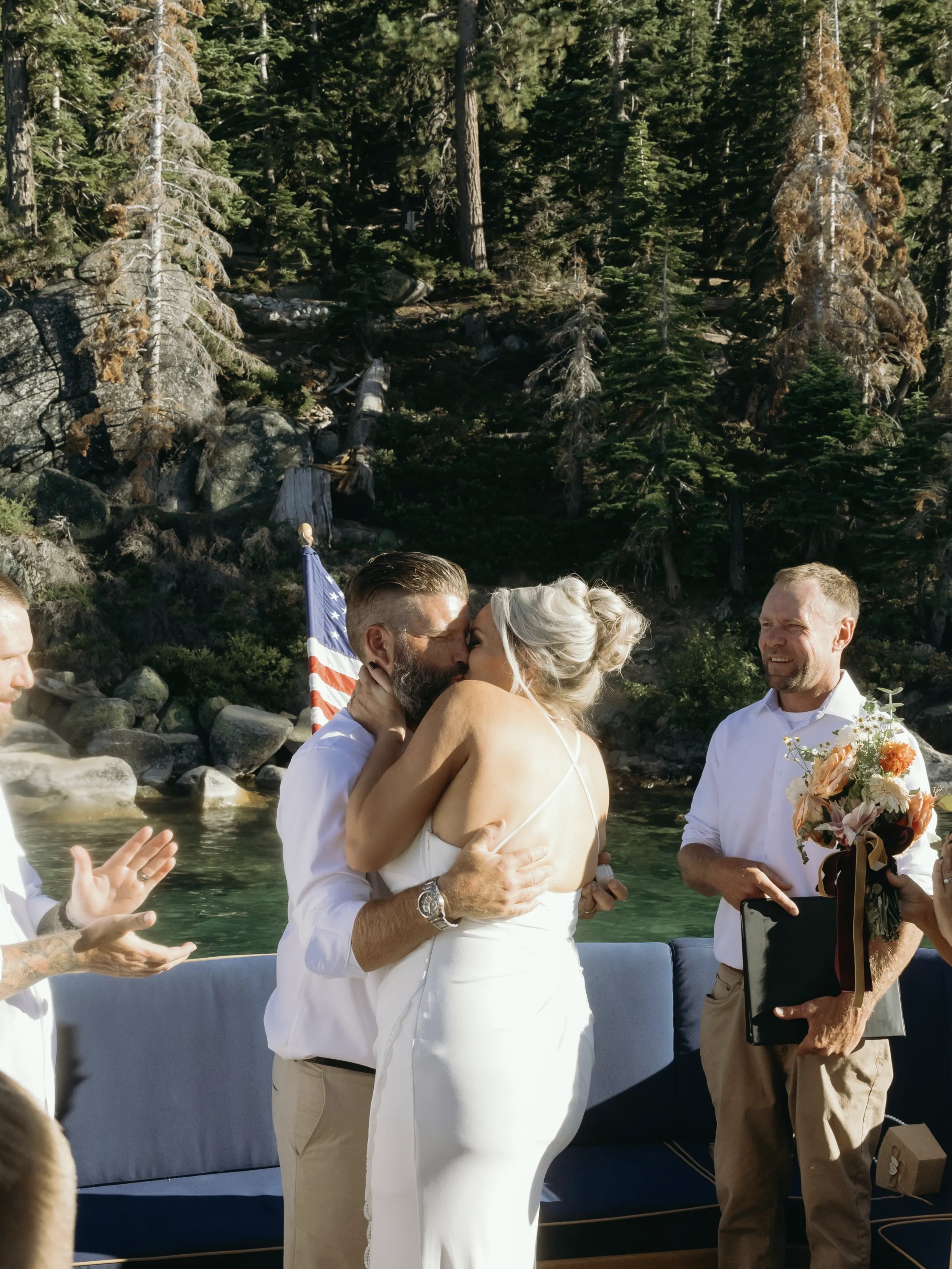 a group of people standing next to a river