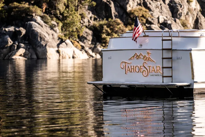 a man riding on the back of a boat in the water