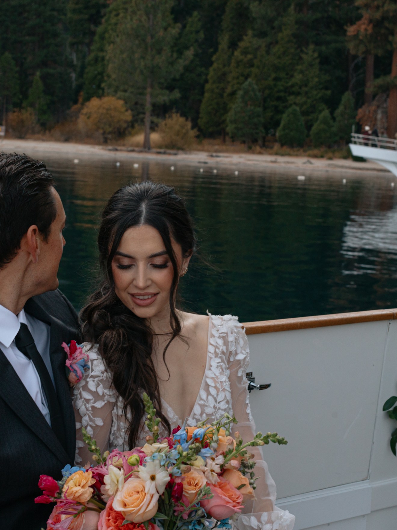 a man and a woman standing in front of water