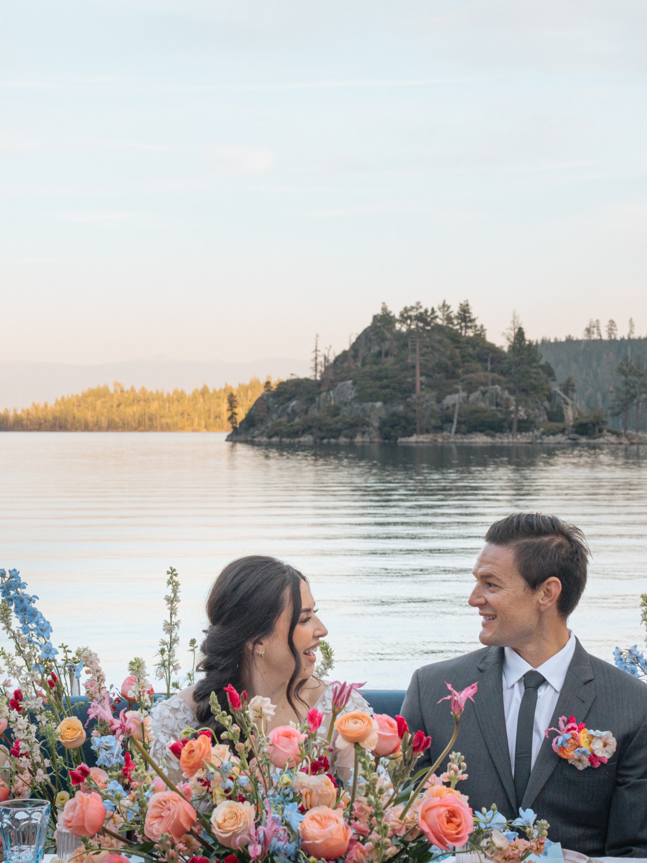 a group of people sitting in front of a body of water
