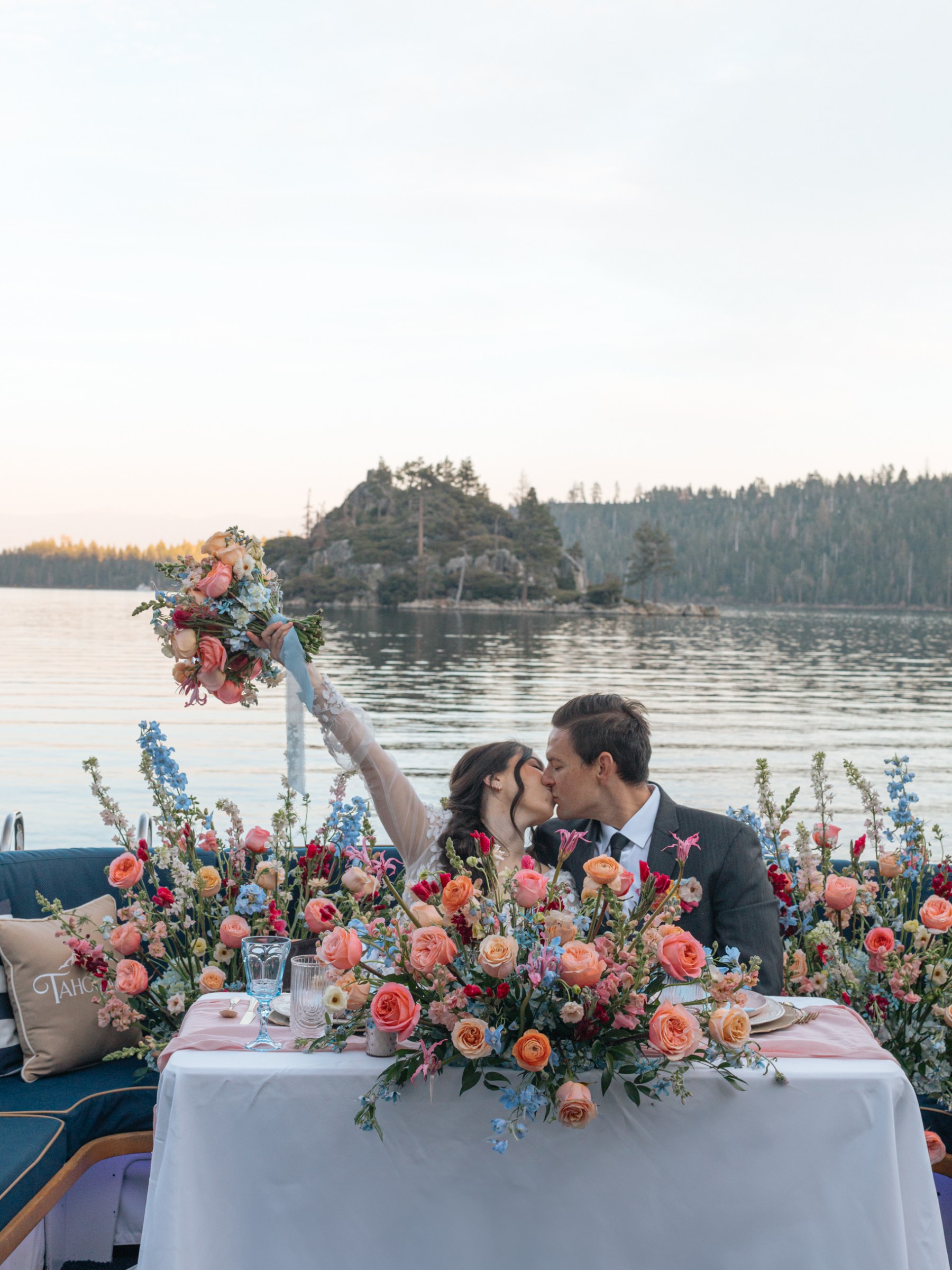a group of people sitting at a table with a flower on water